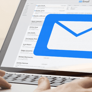 A person using a laptop with an email icon on it.