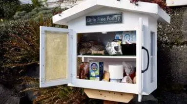 A food pantry in front of a house.